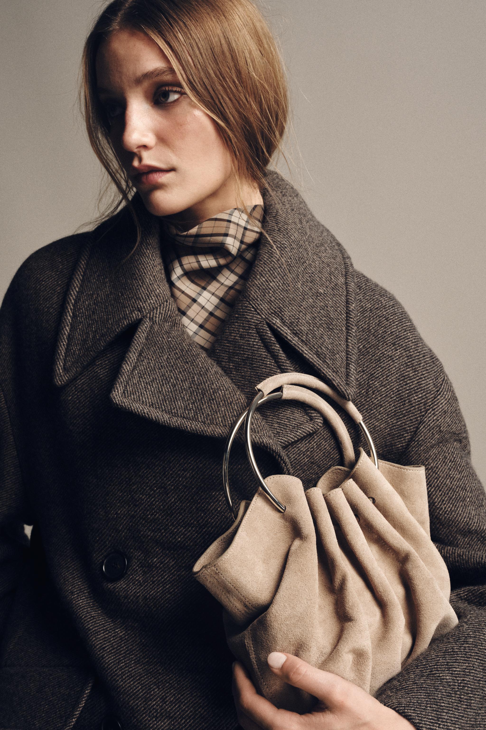 RIGID HANDLE SPLIT LEATHER BUCKET BAG